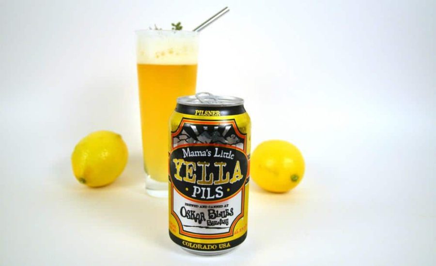 a can of pilsner beer with a cocktail and 2 lemons