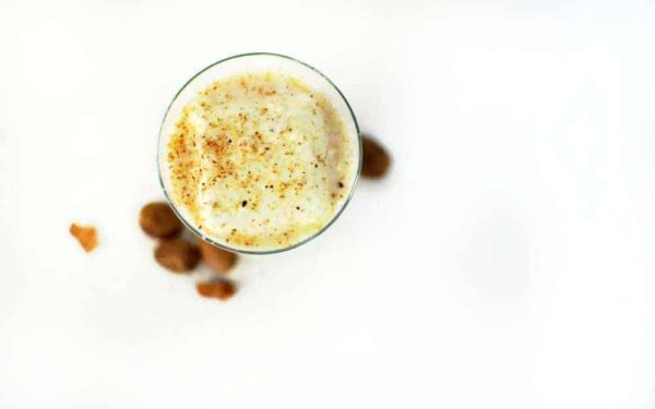a top down photo of a milk punch cocktail with fresh nutmeg