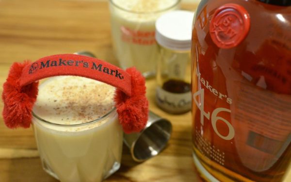 eggnog next to a bottle of liquor