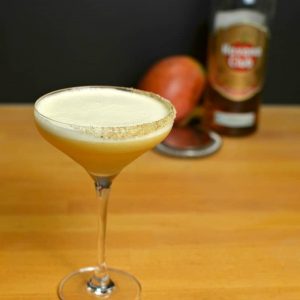 Trouble in Paradise cocktail, an orange egg white cocktail in a chilled coupe glass