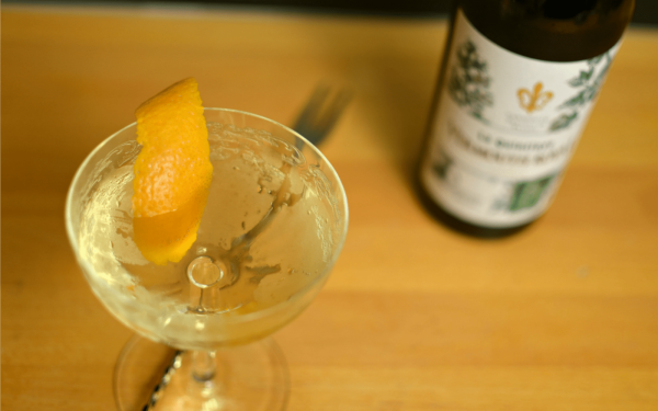 top-down of a pale yellow cocktail in a coupe cocktail glass