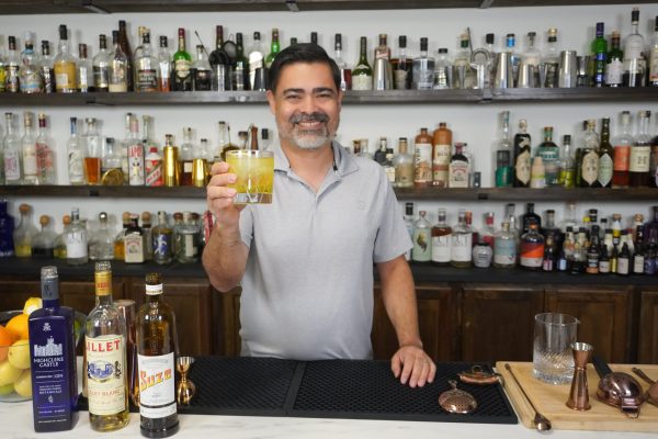 bartender holding a cocktail in a bar