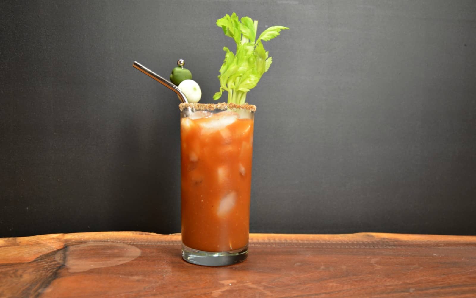 Bloody Mary with celery stick and olive garnish