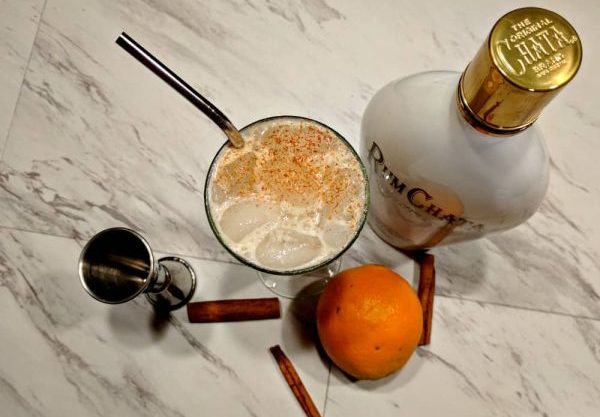 top down view of an orange lassi with its ingredients