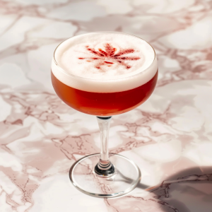 Sour cocktail with egg white foam, made with cognac, in a coupe glass
