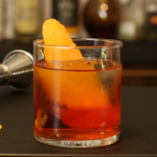 Original Negroni in a cocktail glass with an orange twist