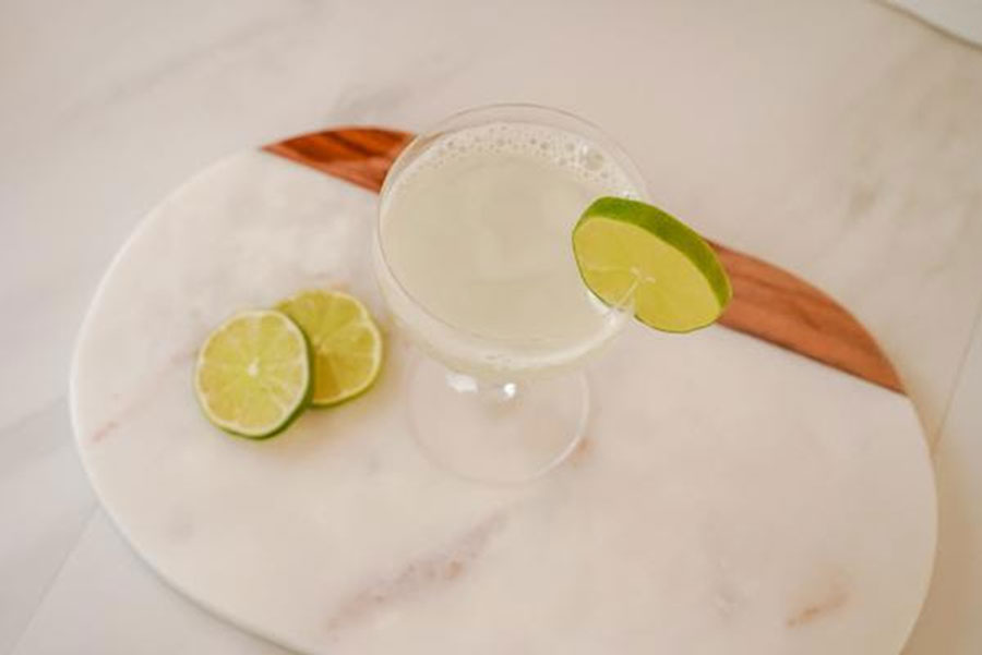 Gimlet drink with lime wedges