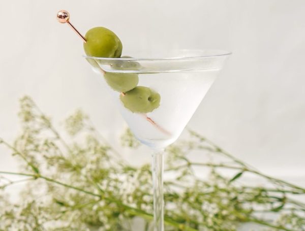 cocktail picks for a variety of drinks with Martini olives in a crystal glass with a heavy base