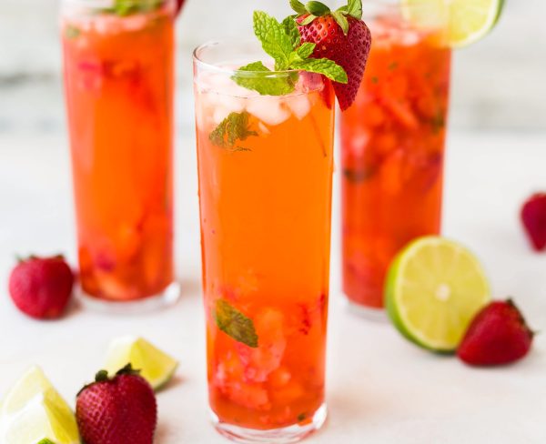 perfect summer cocktail of strawberry mojito in a tall glass with ice