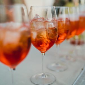 aperol spritz colored orange drinks in wine glass by federica ariemma via unsplash