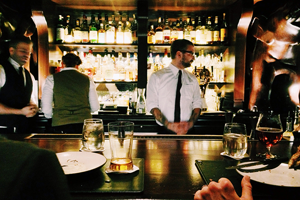 Bartenders working in a cocktail bar by Taylor Davidson via unsplash