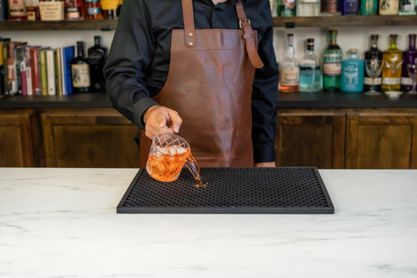 black bar mat with glass spilling on it