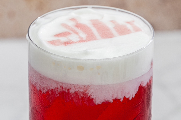 really creative cocktail garnish of stenciled design from bitter bottle - glass, cocktail mist bottle