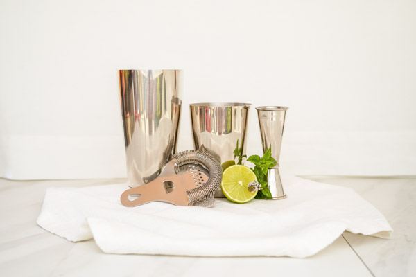 4 piece cocktail set with a shaker, jigger, and strainer