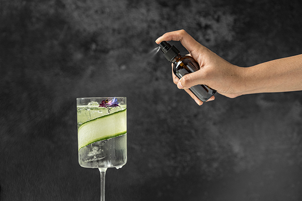 this excellent product, a glass spray bottle or atomizer sprayer bottle, spraying a cocktail with vermouth