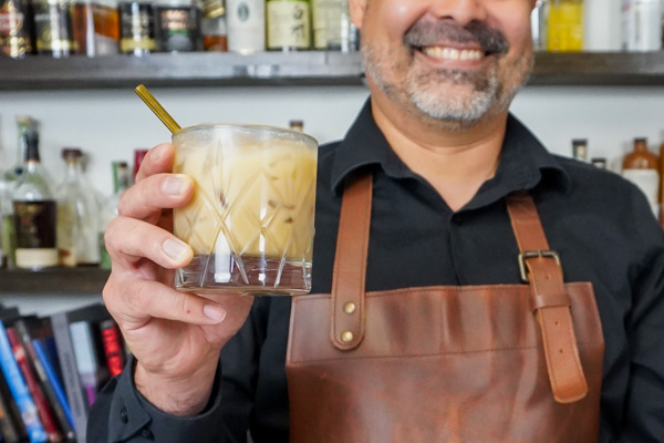 Bartender holding a White Russian delightful drink with the primary ingredient of vodka