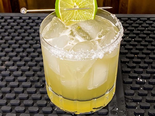 Nonalcoholic party drink recipe of nonalcoholic margarita with fresh lime wedges for garnish