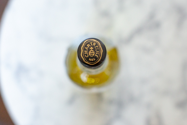 bottle cap of a bright-green herbal liqueur
