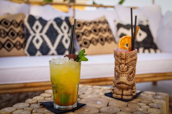 2 tiki drinks, one with 1 ounce pineapple juice and fresh lemon juice, and one in a tiki mug by Kike Zalazar via unsplash