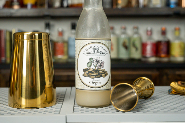 Orgeat bottle with gold barware