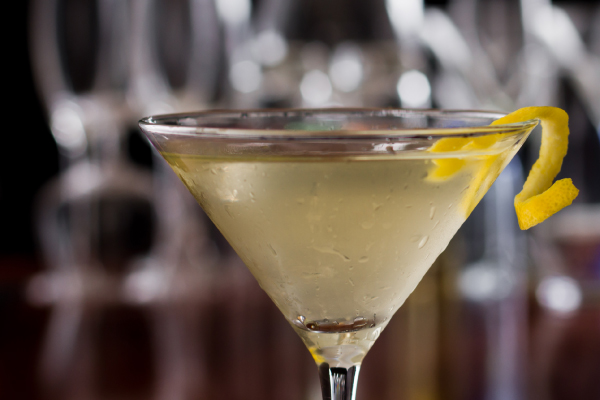 Cocktail with piece of lemon peel