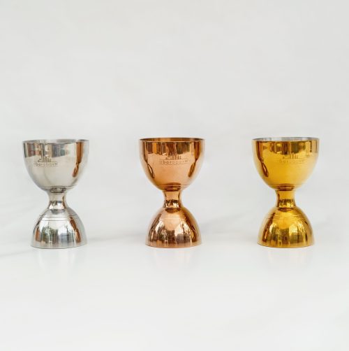 3 bell jiggers lined up on white background