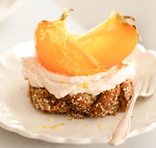 lacy wisps of thicker zest for delicious flavors on top of peach cobbler with a peach slice and whipped cream by karolin-baitinger-unsplash