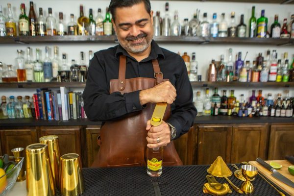 Bartender opening a soda bottle