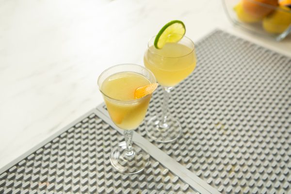 Hemingway cocktail with a variation, in coupe glasses on a bar