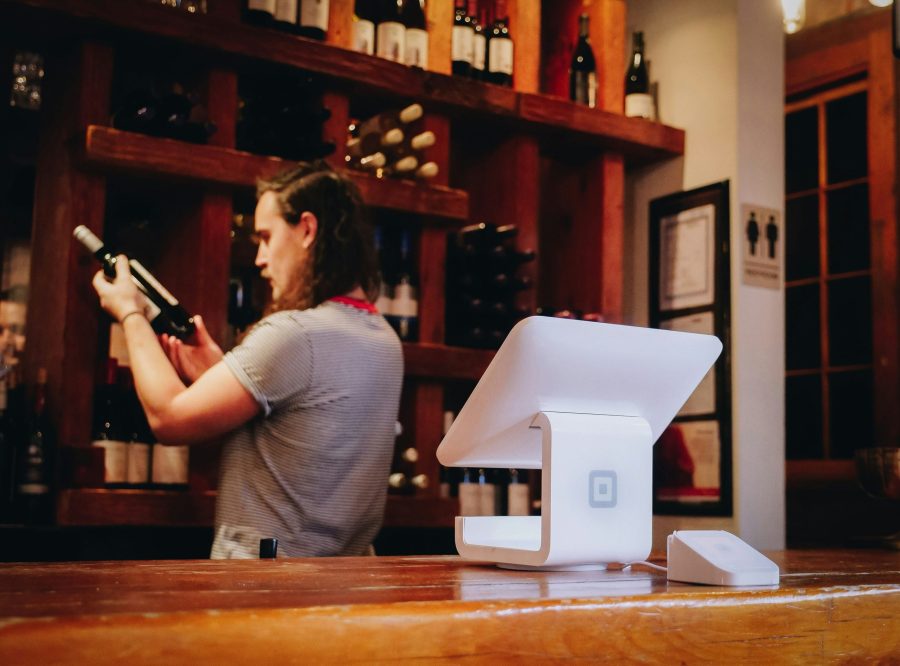 a server taking inventory of wine bottles