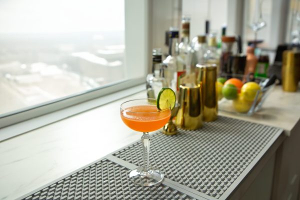 Naked and Famous drink in a coupe glass on a bar