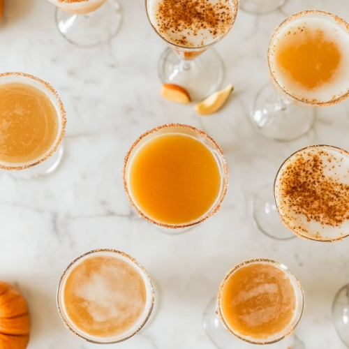 Martinis with a bit of pumpkin puree, taken from top-down, all in cocktail glasses