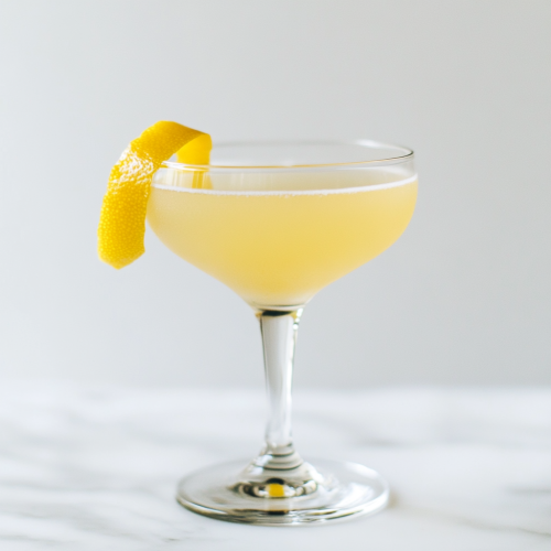 the Alaska, a pale yellow gin cocktail with lemon zest garnish