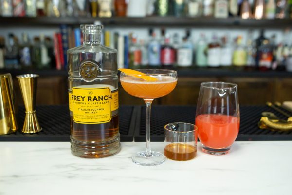 brown derby cocktail ingredients with the finished cocktail on a bar