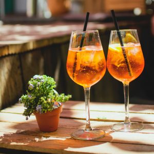 2 wine glasses of orange cocktails