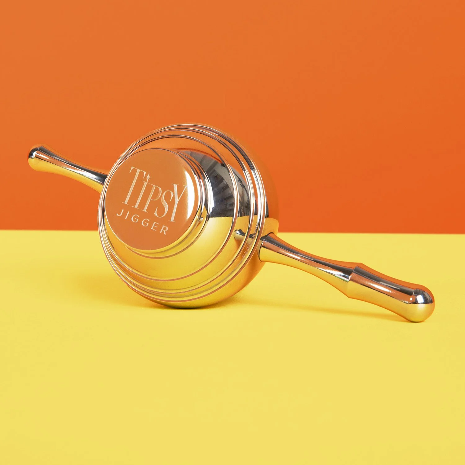 Tipsy jigger, a unique ball shaped jigger with 2 handles that sit on a glass