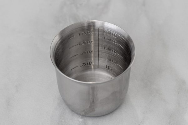 a close-up of a cobbler shaker's jigger lid with clear measurement markings