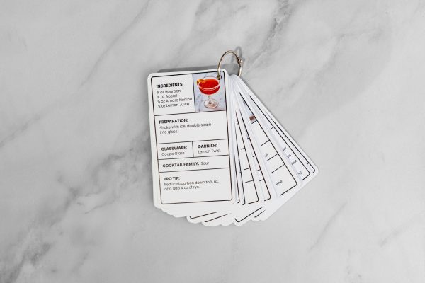 cocktail recipes on easy-to-read cards, lying flat on a bar