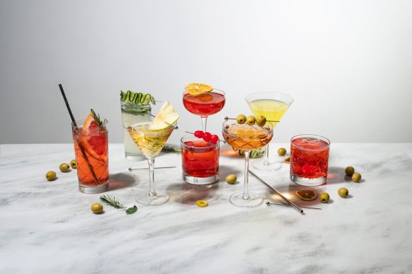 A variety of colorful cocktail in different glassware: coupe glass, rocks glass, Martini glass, etc.